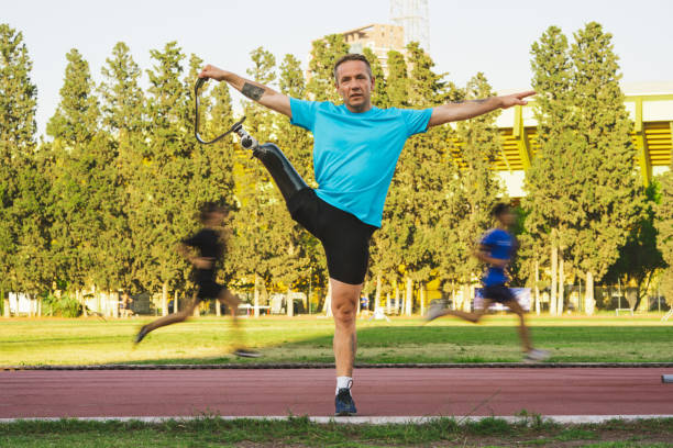 istock Amputee Athlete Warming Up in Sports Field. 1407739012