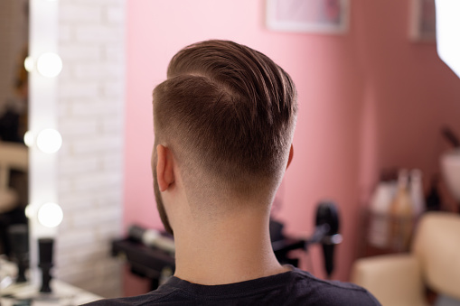 Male head with stylish haircut on barbershop background