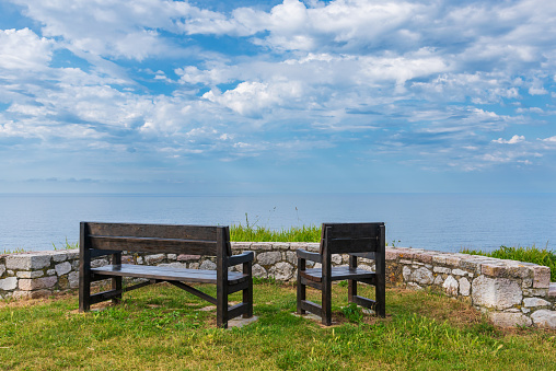 Benches on the Paseo de San Pedro, Llanes, with views of the Cantabrian Sea.