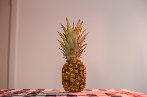 Fresh organic pineapple on cutting board
