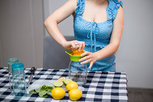 Young girl squeezing fruit