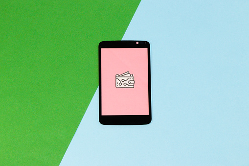 mobile phone with pink screen and e-wallet icon, green-blue background, copy space, creative idea, modern design
