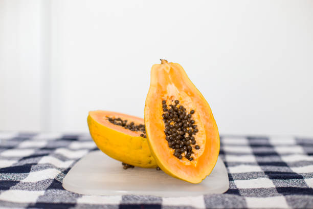 Half of ripe papaya fruit with seeds