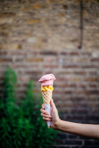 istock Woman holding an ice cream cone 1407745273
