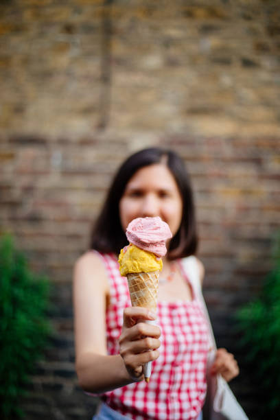 istock Woman holding an ice cream cone 1407745310