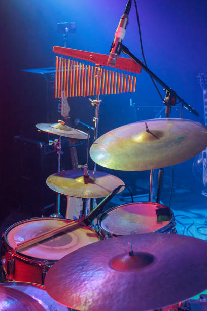istock drum kit waiting for the drummer on the illuminated stage before the concert 1407746324