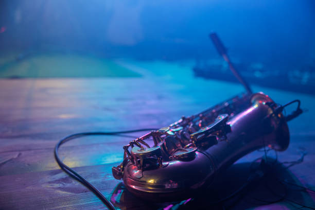 saxophone lying on the empty lit stage before the concert stock photo