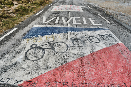painting of team jersey of tour de france participants at Col d Izoard, a mountain pass in the french Alps