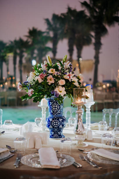 istock rustic modern guest table design, wedding ceremony outdoor, catering and organization. Linen tablecloth, candles and flowers, accessories, glasses and plates on wooden desk for guests outdoor 1407749323