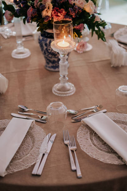 istock rustic modern guest table design, wedding ceremony outdoor, catering and organization. Linen tablecloth, candles and flowers, accessories, glasses and plates on wooden desk for guests outdoor 1407749362