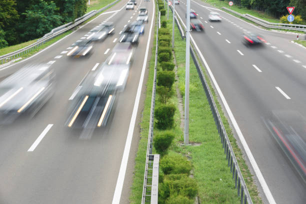 istock Blurred traffic on highway in sunset. Fast blurred motion drive on the highway.  Transportation and travel concept 1407754396