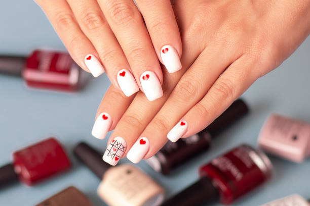 istock Beautiful female hands with creative manicure, hearts design 1407754494