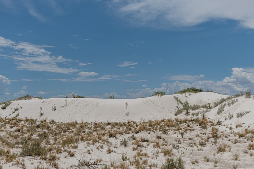 Beautiful gypsum dune vista at the White Sands National Park set against dramatic sky during the monsoon season, Southern New Mexico