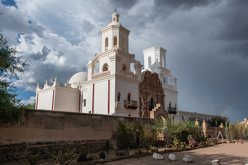 Beautiful vista of the San Xavier del Bac Mission in Tucson, Arizona, under dramatic monsoon sky