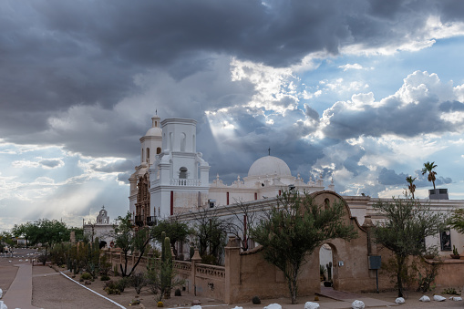 Beautiful vista of the San Xavier del Bac Mission in Tucson, Arizona, under dramatic monsoon sky