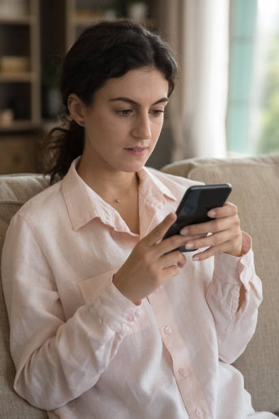 istock Focused thoughtful beautiful millennial girl typing text message on smartphone 1407759016