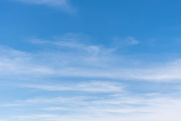 Cirrus Clouds in a Blue Sky Cirrus clouds appear in a blue sky over Rogers Lake near Flagstaff, Arizona, USA. moody sky stock pictures, royalty-free photos & images