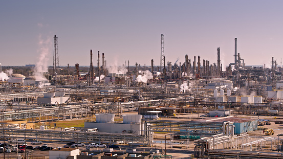 Aerial shot of steaming chemical plants and oil refineries in La Marque, Texas