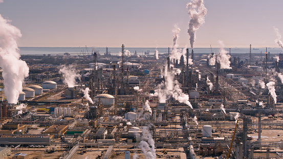 Aerial shot of steaming chemical plants and oil refineries in La Marque, Texas