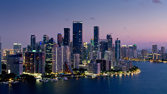 Aerial shot of skyscrapers in Brickell, Miami illuminated in pre-dawn twilight on a spring morning.
