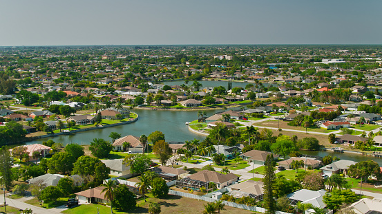 Aerial shot of Cape Coral, Florida on a sunny day in spring. Cape Coral is a coastal city in Florida known as the Venice of America.\n\nAuthorization was obtained from the FAA for this operation in restricted airspace.