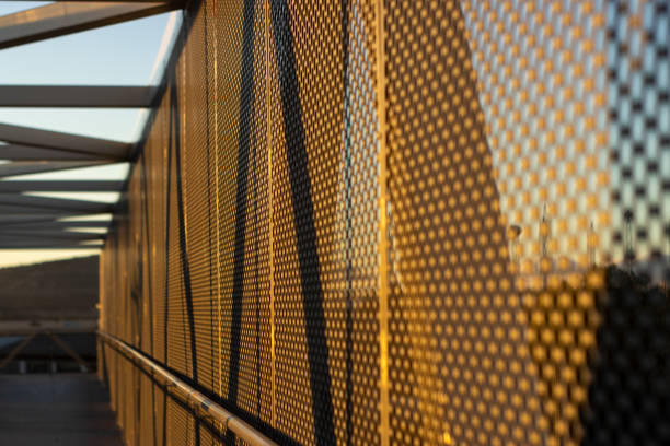 aluminum composite panels or cladding with perforated sheets on modern building facade on sunset, Abstract architecture background concept.