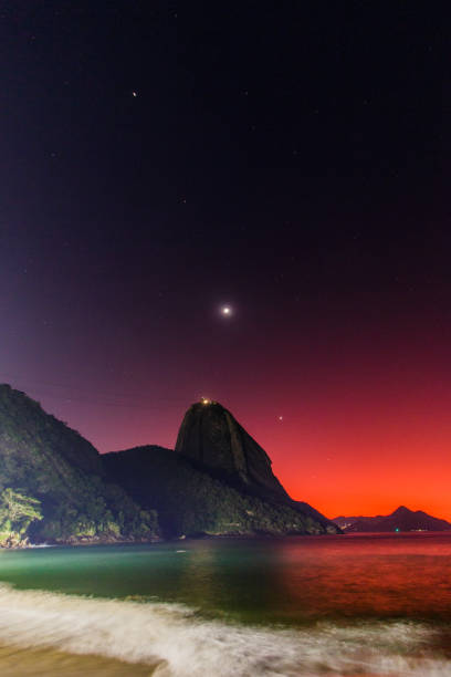 Planetary alignment at dawn on the red beach of Urca in Rio de Janeiro, Brazil stock photo