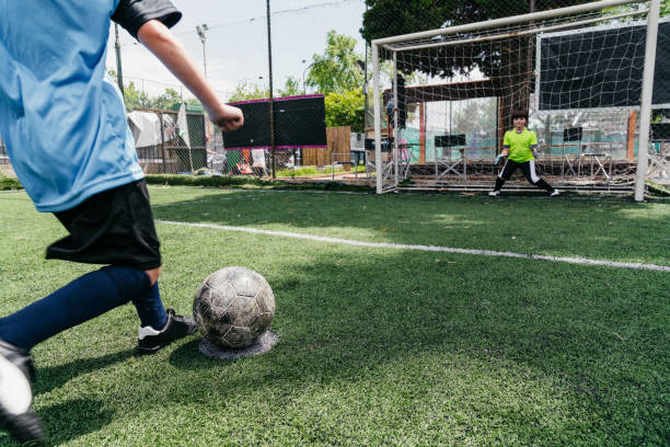istock Young boy kicking a penalty kick 1407767792
