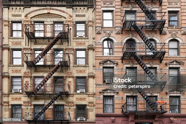 Old Fashioned Manhattan Apartment Building Facade With Ornate Decorative Stone Carving And External Fire Escape Ladders Stock Photo - Download Image Now