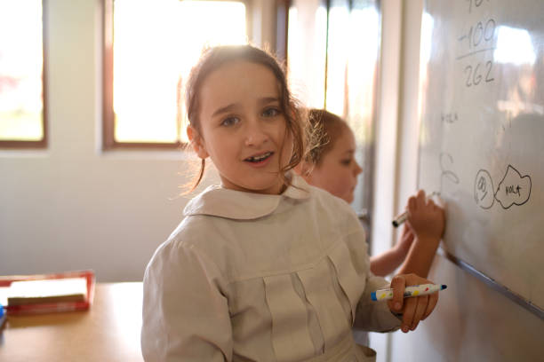 istock children writing on the school board 1407770137
