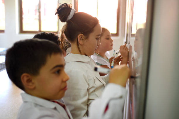 istock children writing on the school board 1407770217