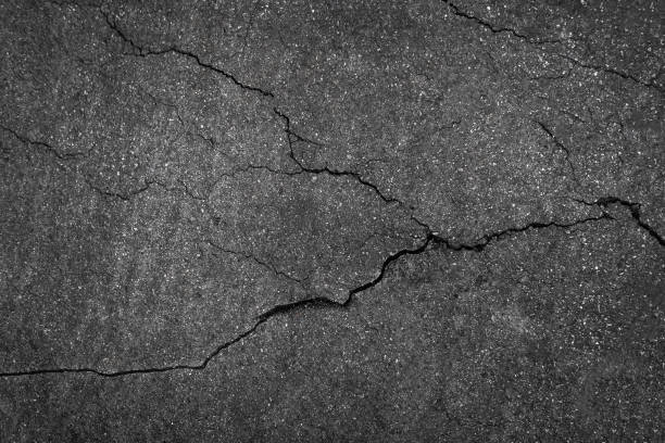 istock Crack background texture of rough asphalt top view 1407775143