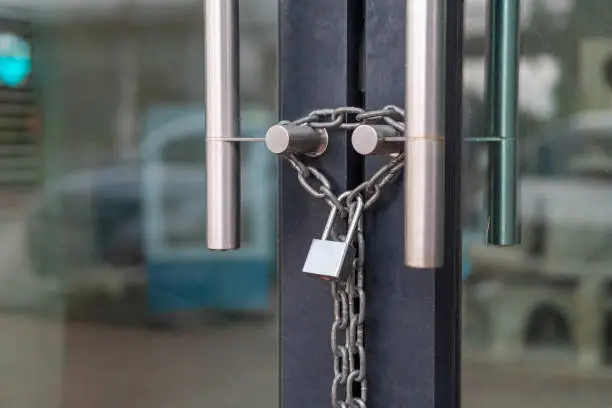 Photo of Generic storefont door chained shut and locked with a chain an padlock