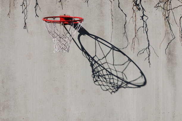 Close-up of Basketball hoop shadow on a white concrete wall with copy space.