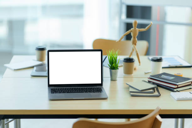 istock Laptop computer with blank white screen on table in the office. mock up. 1407787248