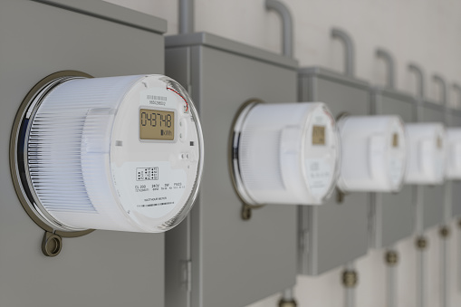 Close-up View Of Electric Meters On Wall With Blurred Background