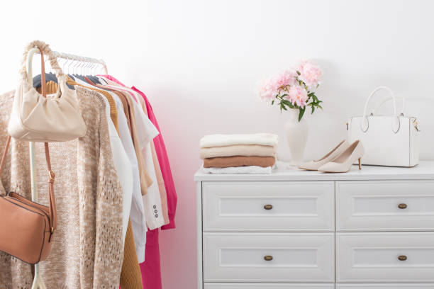 istock female clothes on hangers  in  white room 1407789135