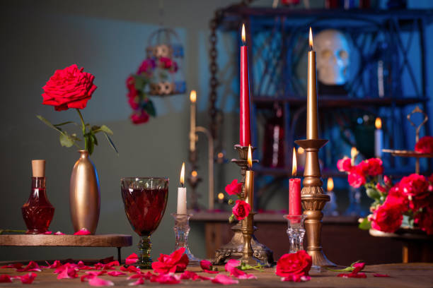 istock magic potion with red roses and burning candles in dark room 1407789136