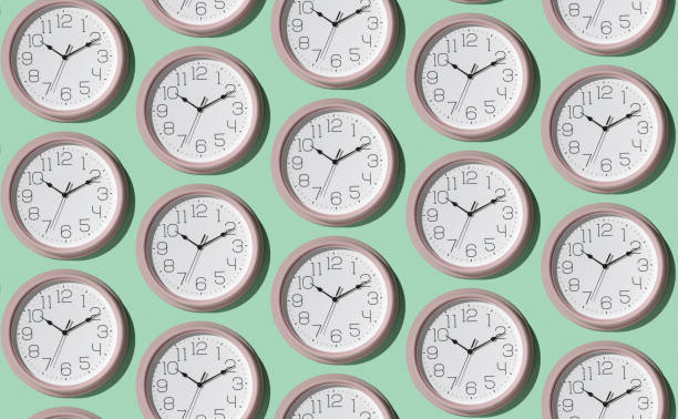 istock A pattern of a large number of large wall clocks on a light background. 1407789343