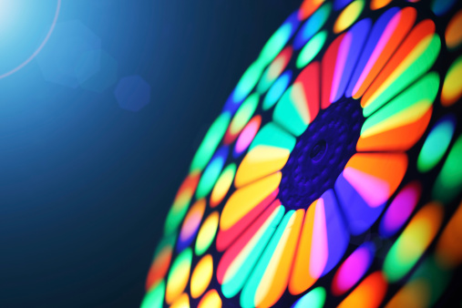 Illuminated colorful spinning wheel, motion blur background.