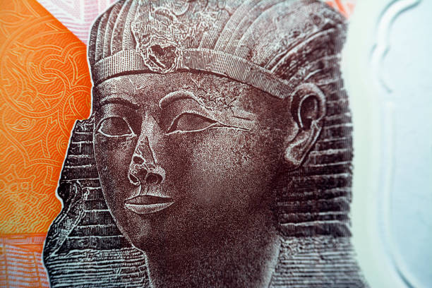 Queen Hatshepsut closeup view from the reverse side of the new first Egyptian 10 LE EGP ten pounds plastic polymer banknote with a part of the great pyramid of Giza Khufu pyramid Queen Hatshepsut closeup view from the reverse side of the new first Egyptian 10 LE EGP ten pounds plastic polymer banknote with a part of the great pyramid of Giza Khufu pyramid, selective focus queen hatshepsut stock pictures, royalty-free photos & images