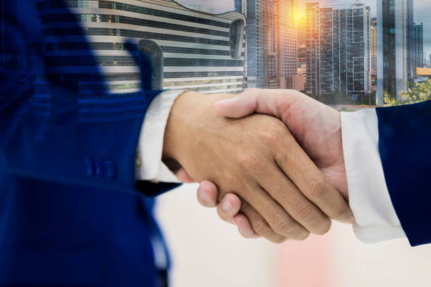 istock Close up of handshake on abstract city background. Teamwork concept. 1407793943