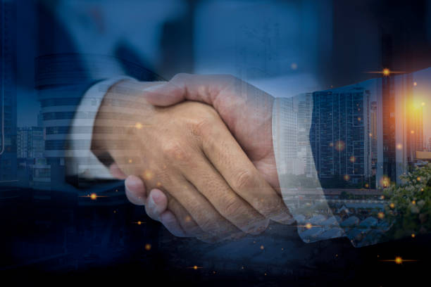 istock Close up of handshake on abstract city background.Teamwork concept. Double exposure. 1407793946