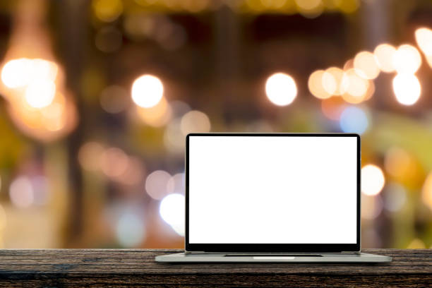 istock Desk Laptop with blank screen on table blur background with bokeh background 1407794848