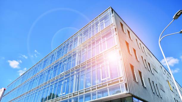istock Modern office building with glass facade on a clear sky background. 1407795986