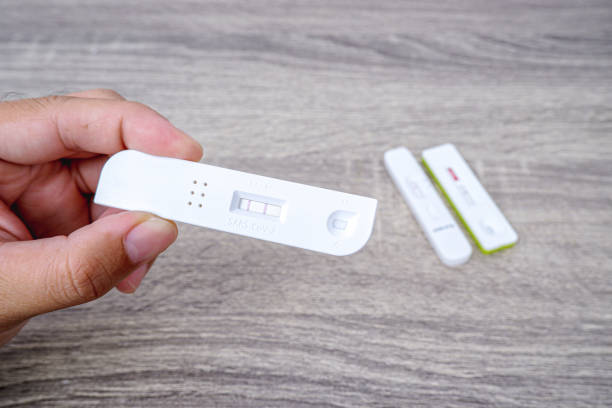 istock Covid-19 Test cassette with positive result in the hand 1407799195