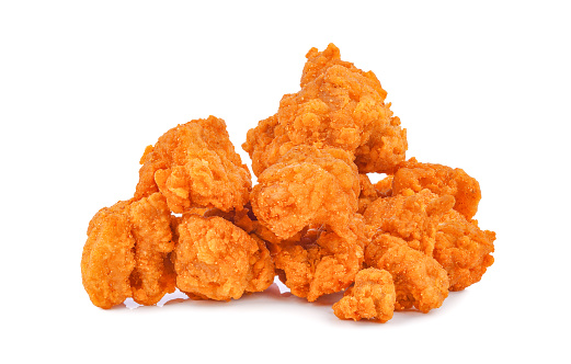 Heap of fried spicy popcorn chicken isolated on white background.