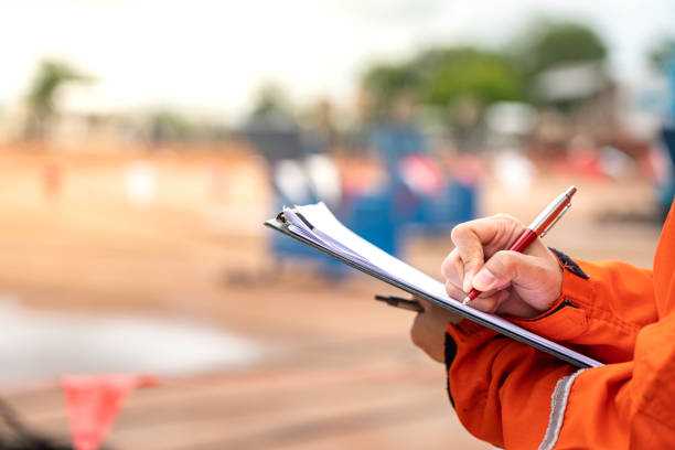 istock Writing note on paper - Audit and inspection in oil field operation. 1407802516