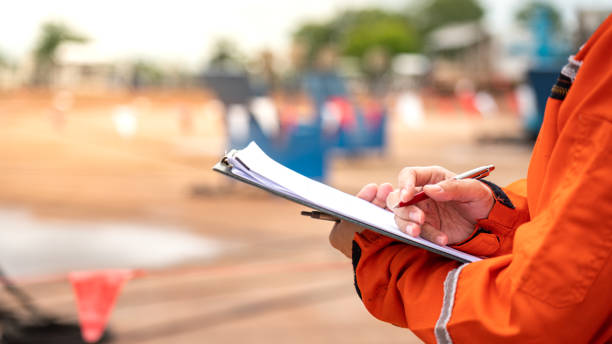 istock Writing note on paper - Audit and inspection in oil field operation. 1407802517
