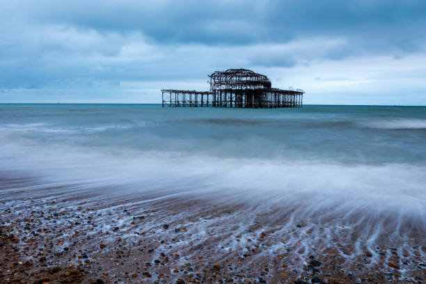 West Pier Ruins Brighton Seen better days, waves receding at the ruins of Brighton west pier, east Sussex south east England brighton england stock pictures, royalty-free photos & images